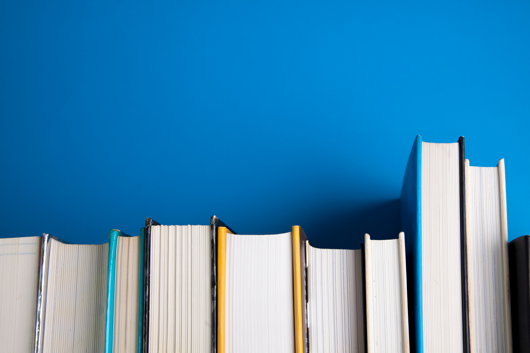 Stack of books on blue background.